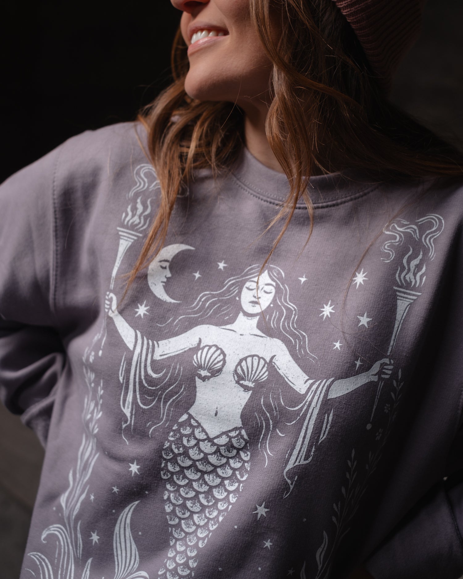 Woman wearing an Art Disco sweatshirt with a mermaid design, in Whitby North Yorkshire