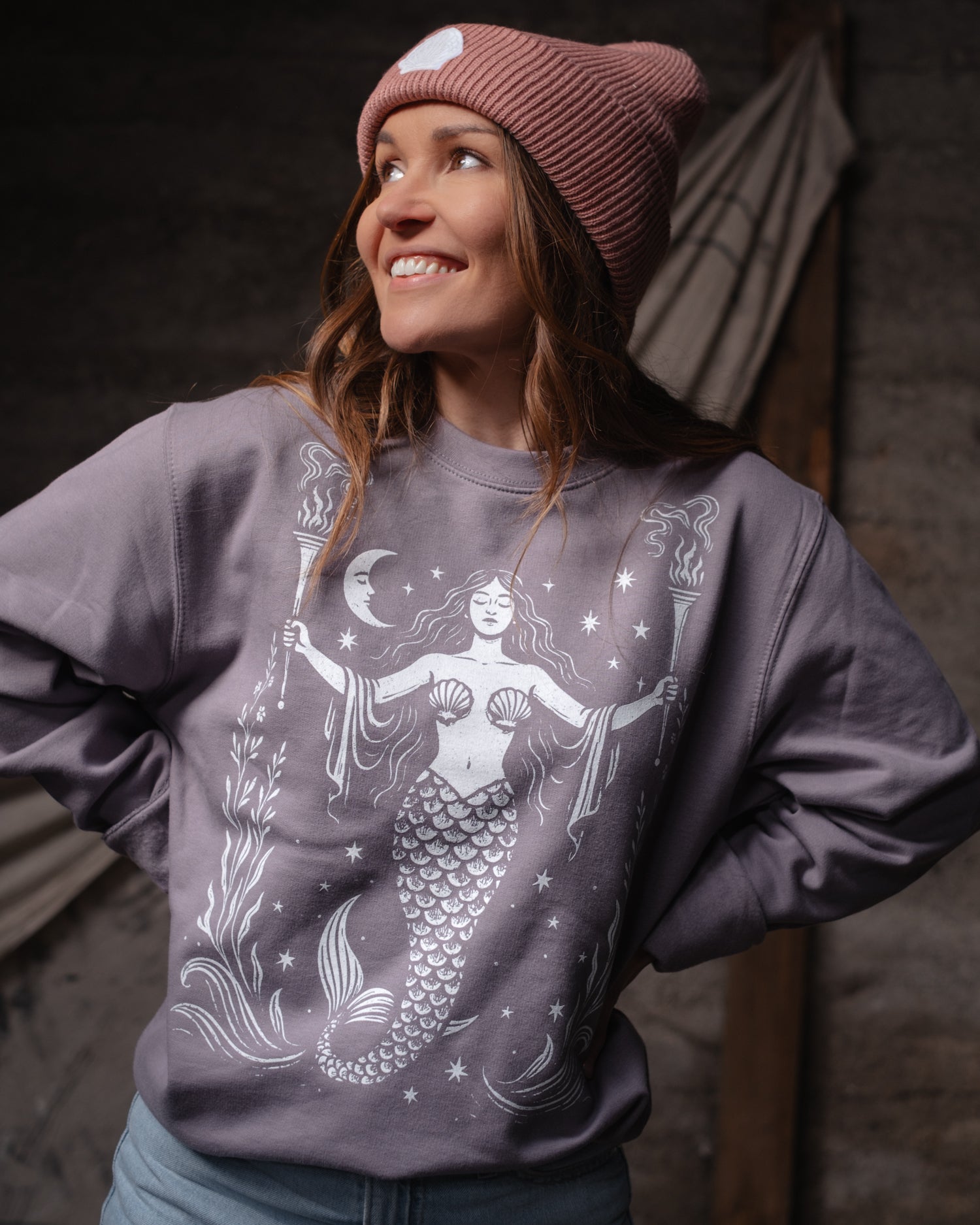 Woman wearing an Art Disco sweatshirt with a mermaid design, in Whitby North Yorkshire